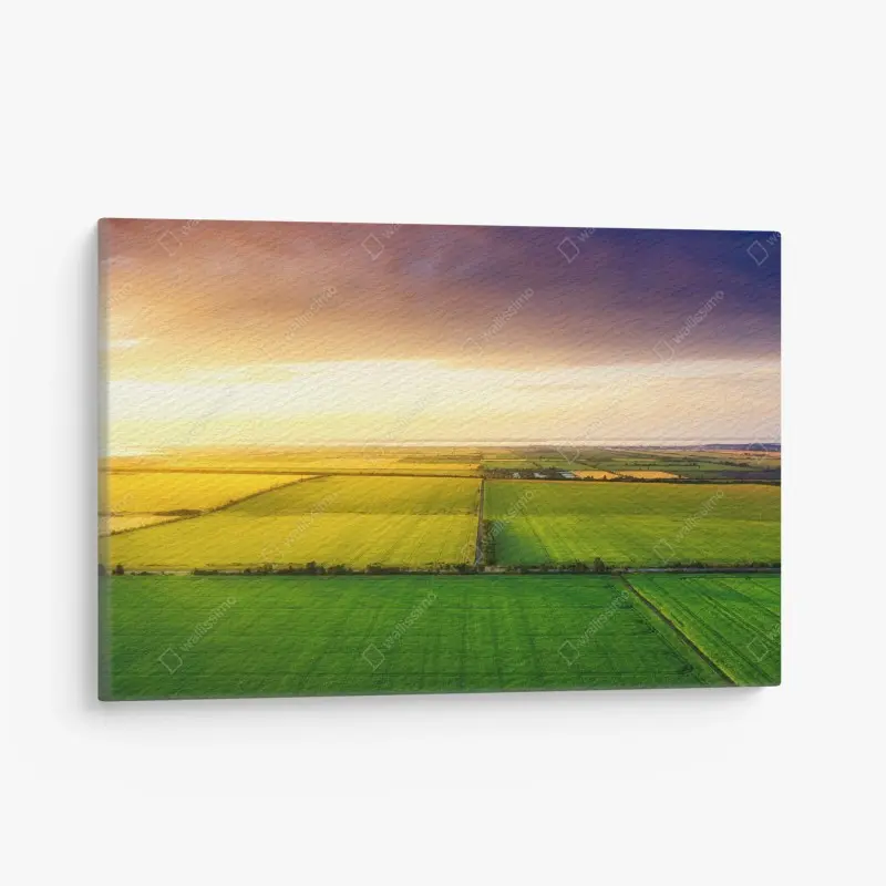 Leinwandbild sonnenuntergang über grünen feldern