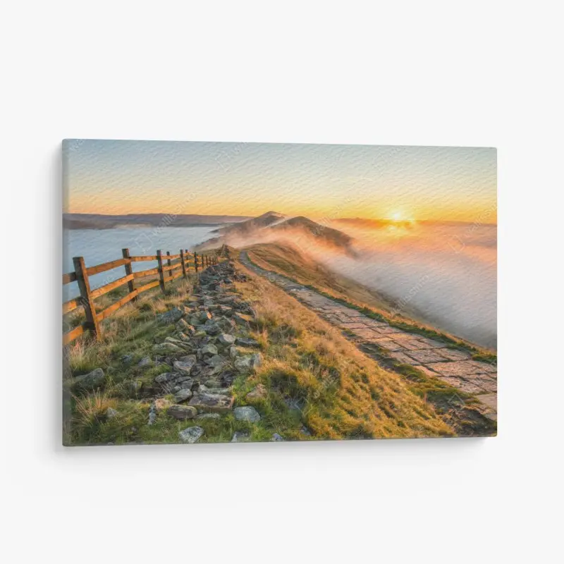 Leinwandbild sonnenaufgang über einem nebligen bergrücken mit steinweg