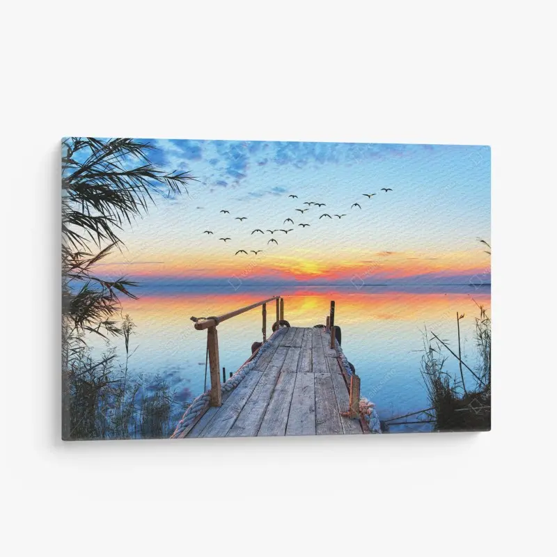 Leinwandbild steg bei sonnenuntergang über ruhigem see