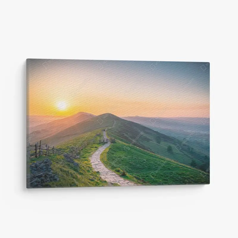 Leinwandbild sonnenaufgang über grünen hügeln mit steinweg