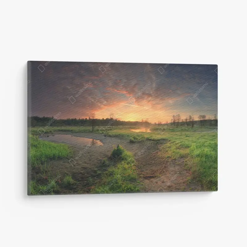 Leinwandbild sonnenuntergang über einer ruhigen wiese