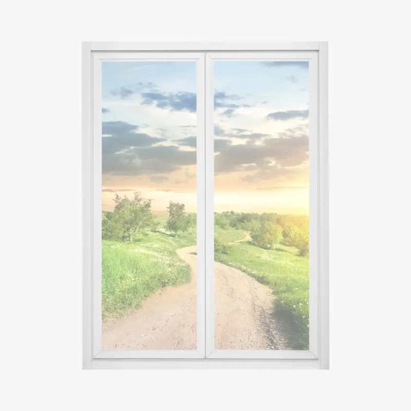 Fensteraufkleber sonnenuntergang über einem feldweg durch grüne wiese