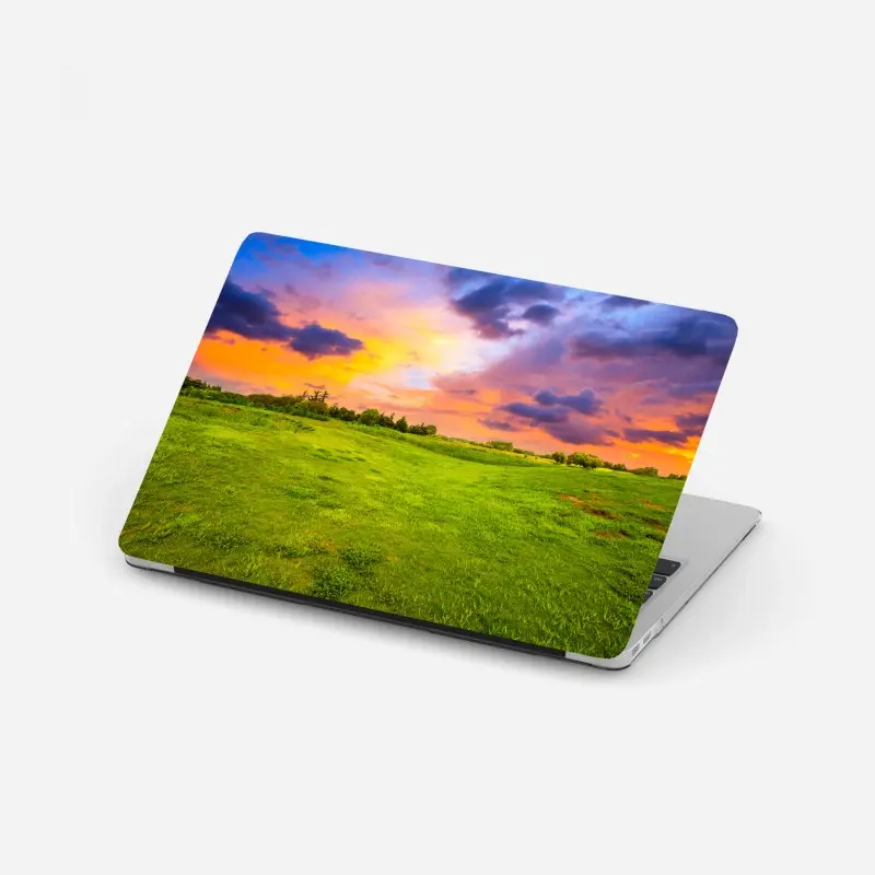 Laptop-Aufkleber sonnenuntergang über grüner wiese