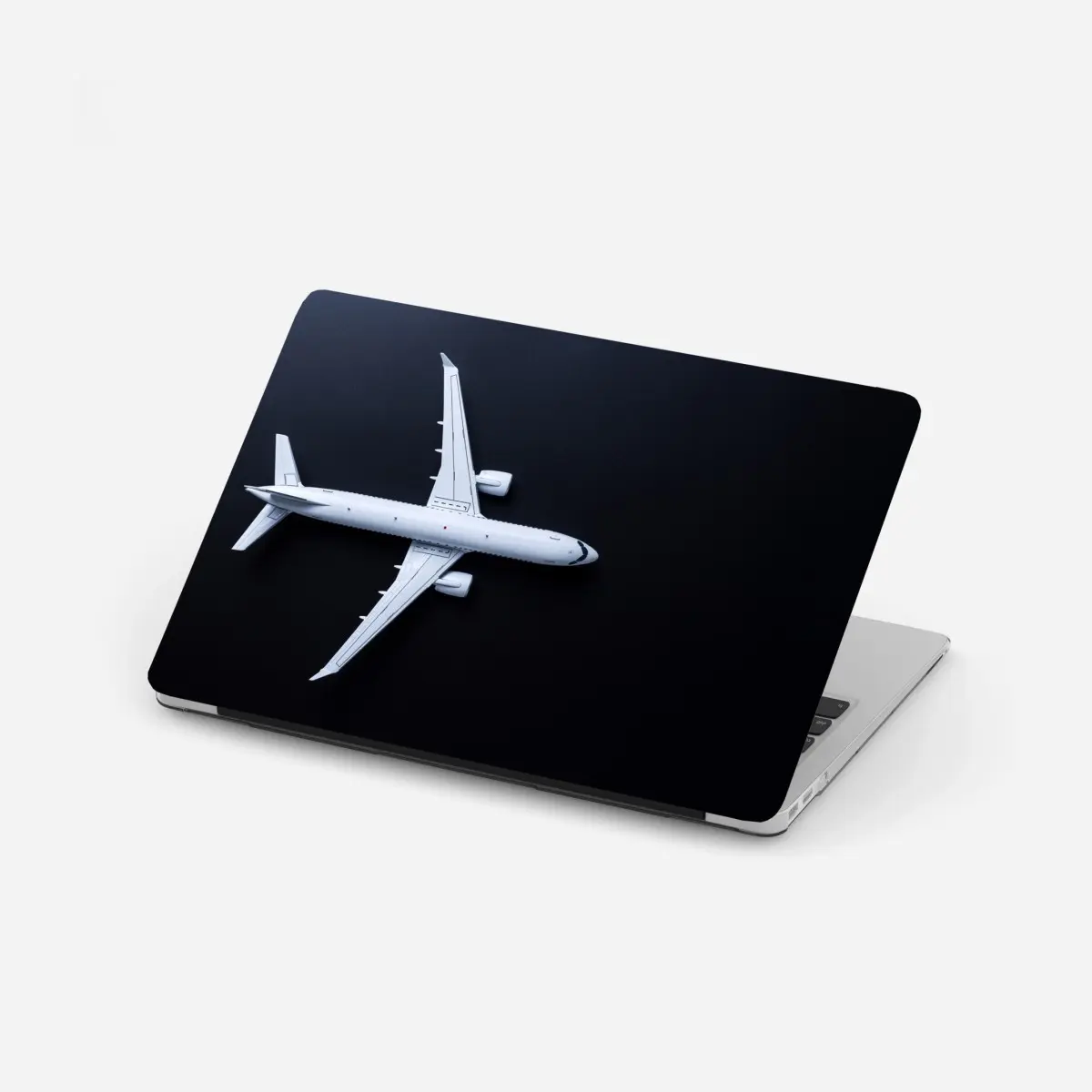 Laptop-Aufkleber weißes flugzeug von oben auf schwarzem hintergrund – Pixers®