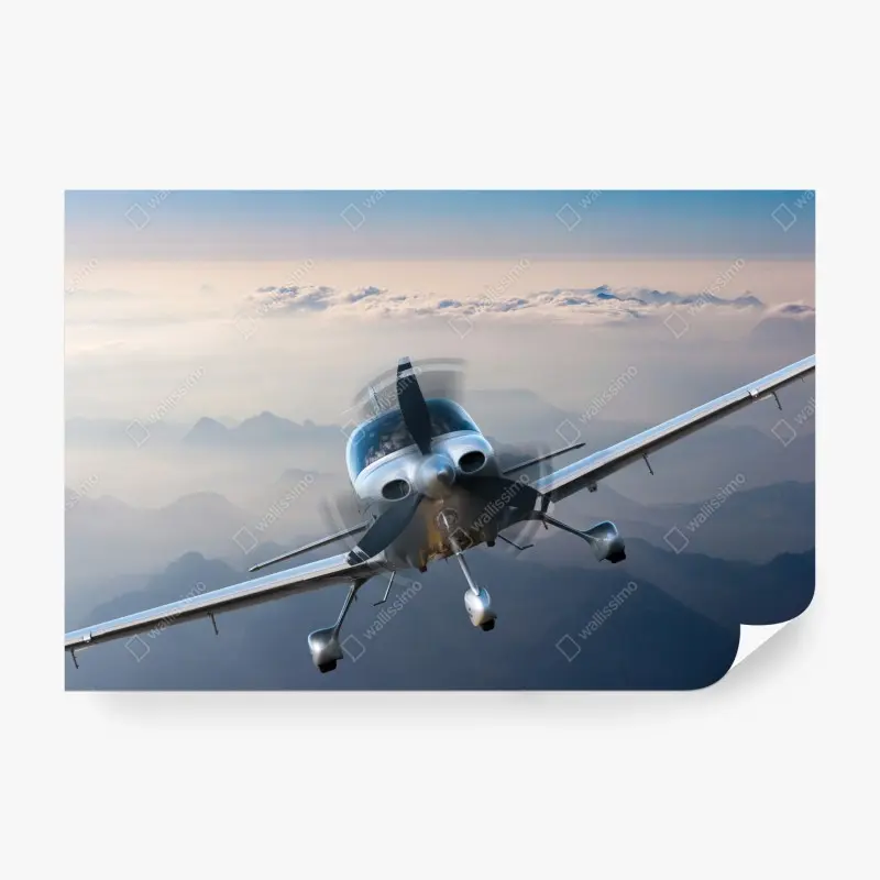 Fototapete silbernes propellerflugzeug über nebeligen bergen