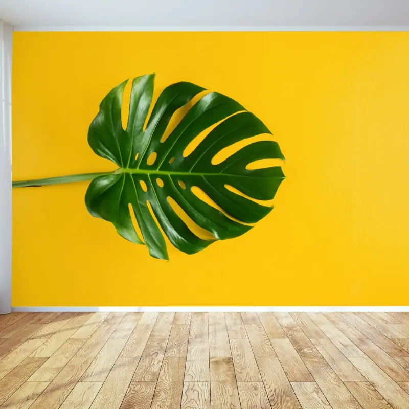 Fototapete monstera-blatt auf gelbem hintergrund