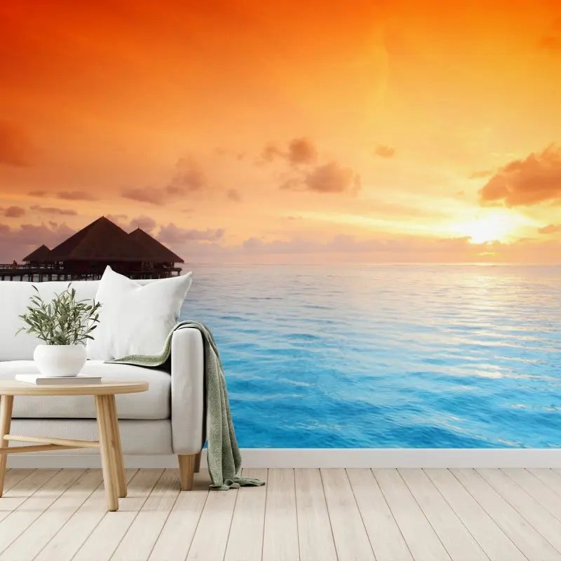 Fototapete sonnenuntergang über türkisblauem meer und bungalows über wasser