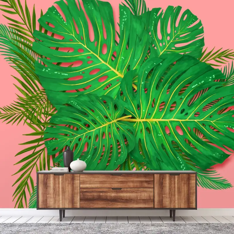 Fototapete monstera- und palmblätter vor rosa hintergrund