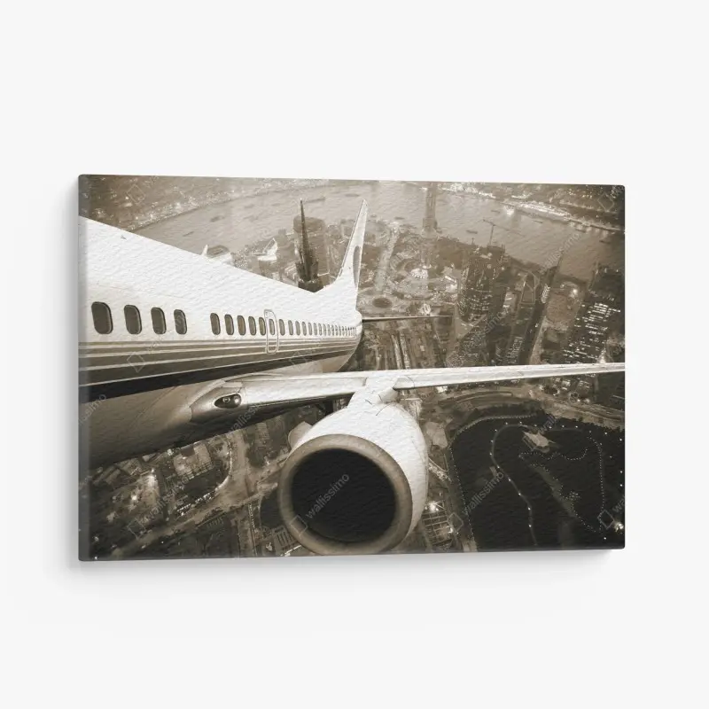 Leinwandbild sepia luftaufnahme über der stadt mit flugzeugflügel